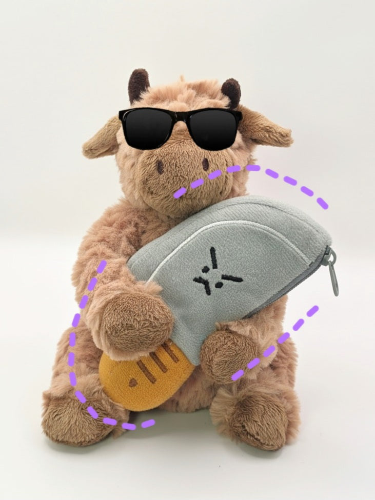 Plush toy cow with sunglasses and a gray bag on a white background