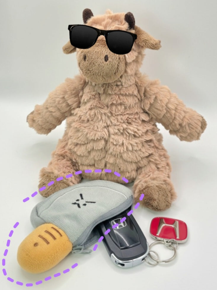Plush toy cow with sunglasses, car key holder, and keychain on a white background