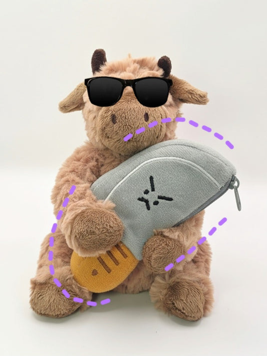 Plush toy cow with sunglasses and a gray bag on a white background