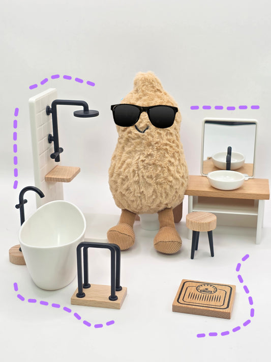 A stuffed animal with sunglasses in a kitchen setting with miniature furniture.